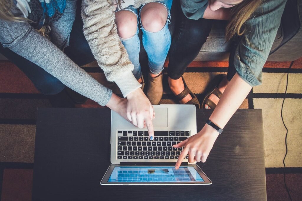 Two people collaborating on a laptop, working on strategy and planning