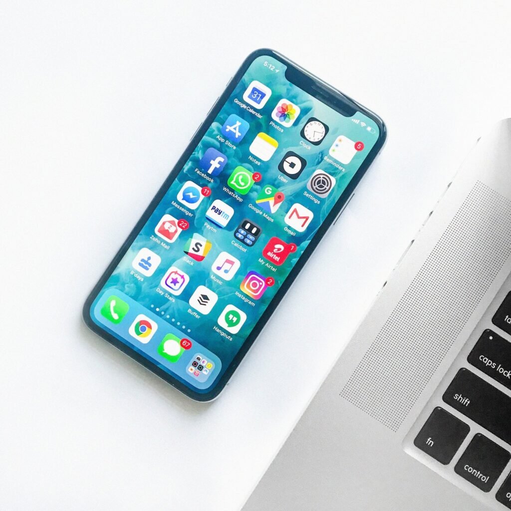 Smartphone screen showing multiple social media apps including Facebook, Instagram, TikTok, and WhatsApp — representing business use of multiple platforms