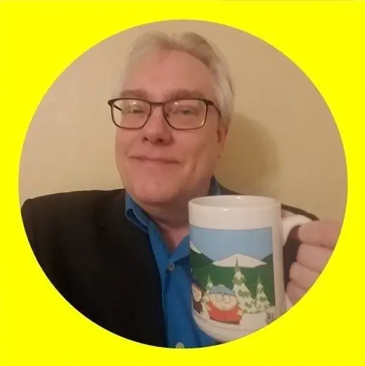 Business coach Steve Feld smiling while holding a coffee mug, testimonial for Karen Hewitt
