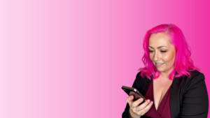Karen Hewitt smiling while using her phone with a pink background – Blossom To Success branding image.